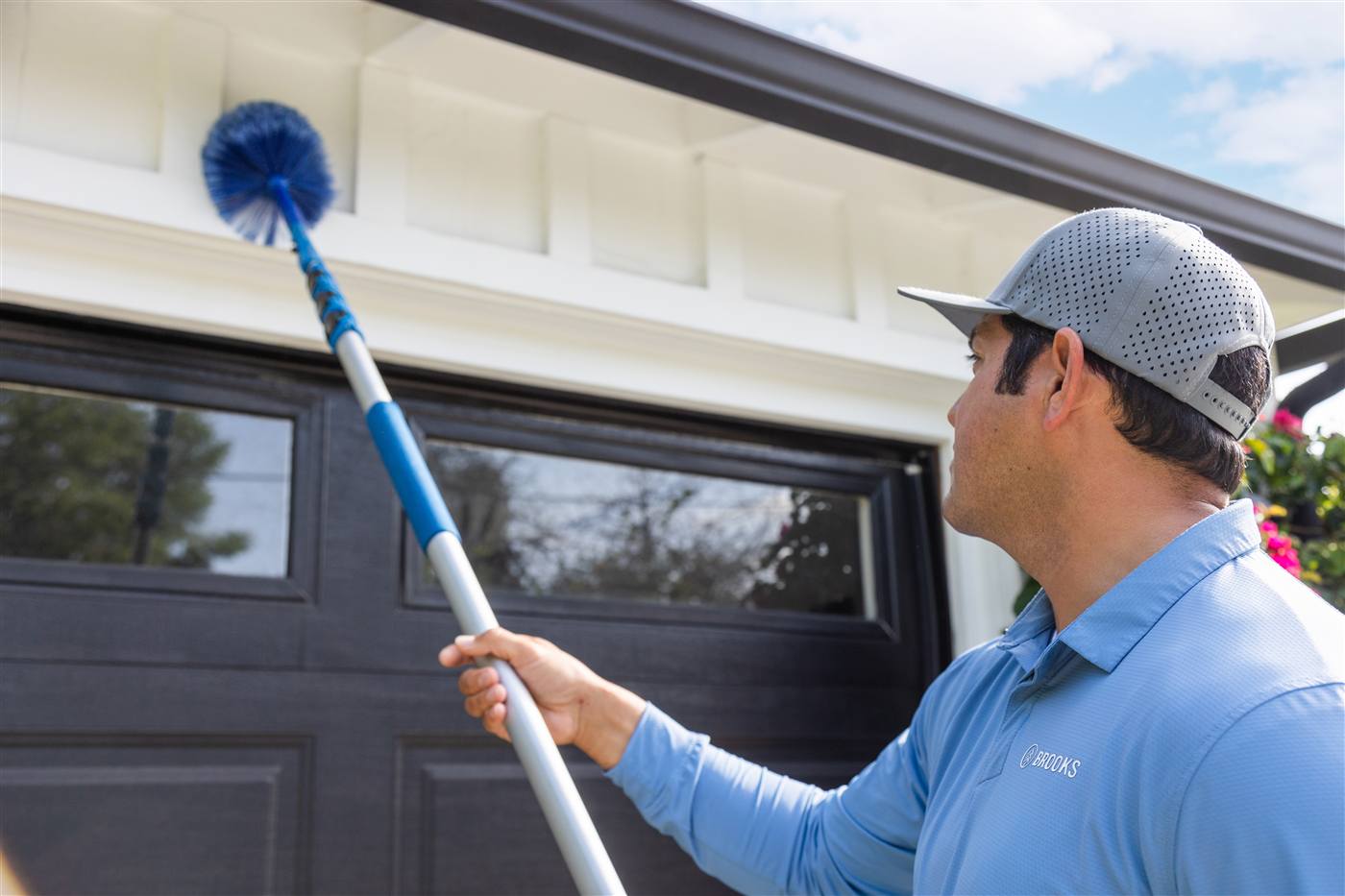 Brooks technician treating the exterior eaves of a home